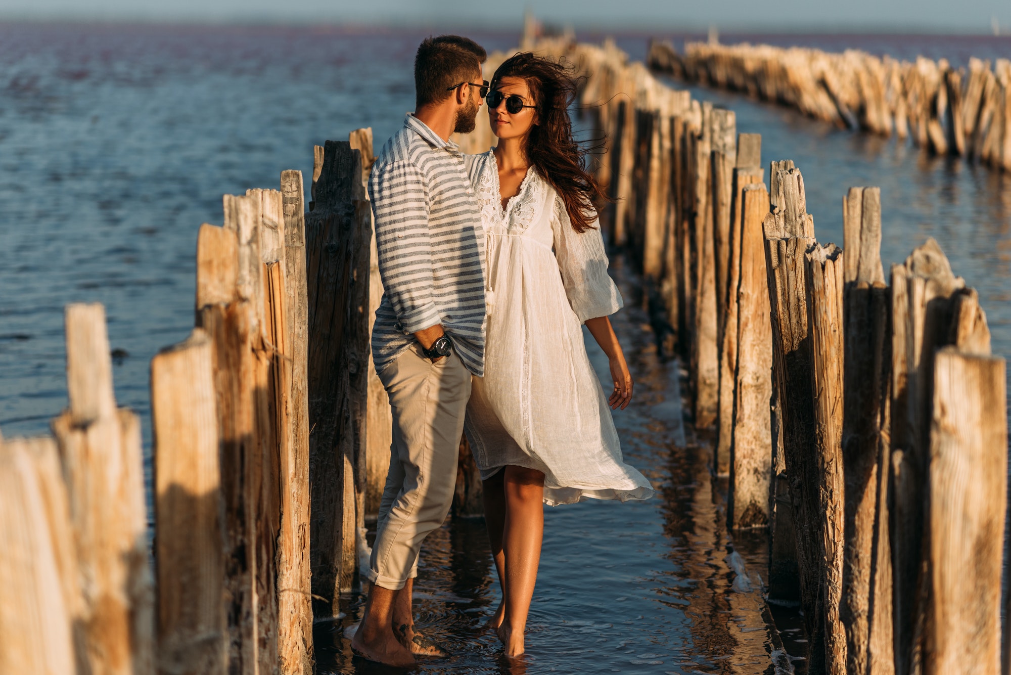 A couple in love on the seashore. A happy couple on a honeymoon by the sea