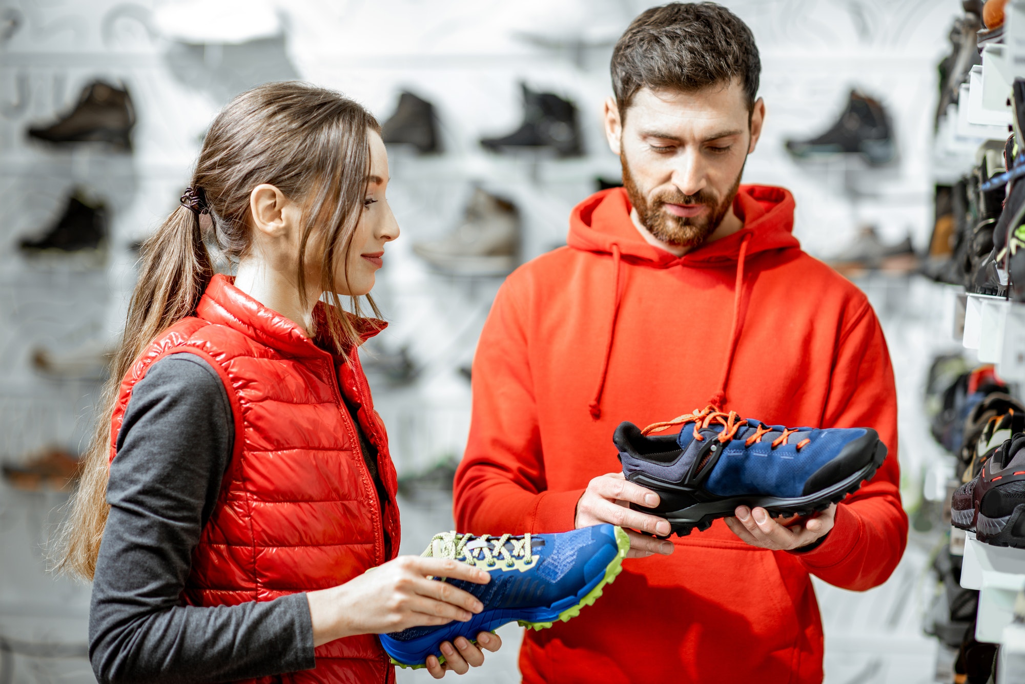 Man and woman choosing shoes in the shop